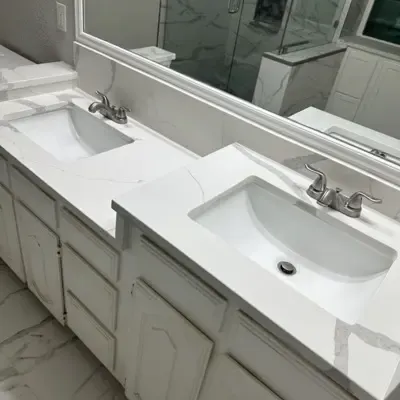 Double sink vanity with marble countertop in remodeled bathroom — Frisco, TX | Goldstar Renovations