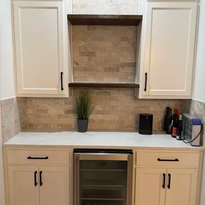 Custom wet bar cabinetry with stone backsplash and beverage fridge — Prosper, TX | Goldstar Renovations