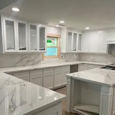 White kitchen remodel with glass upper cabinets and marble island — Plano, TX | Goldstar Renovations